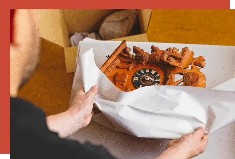 packing a valuable antique in wrapping paper to protect it during transit