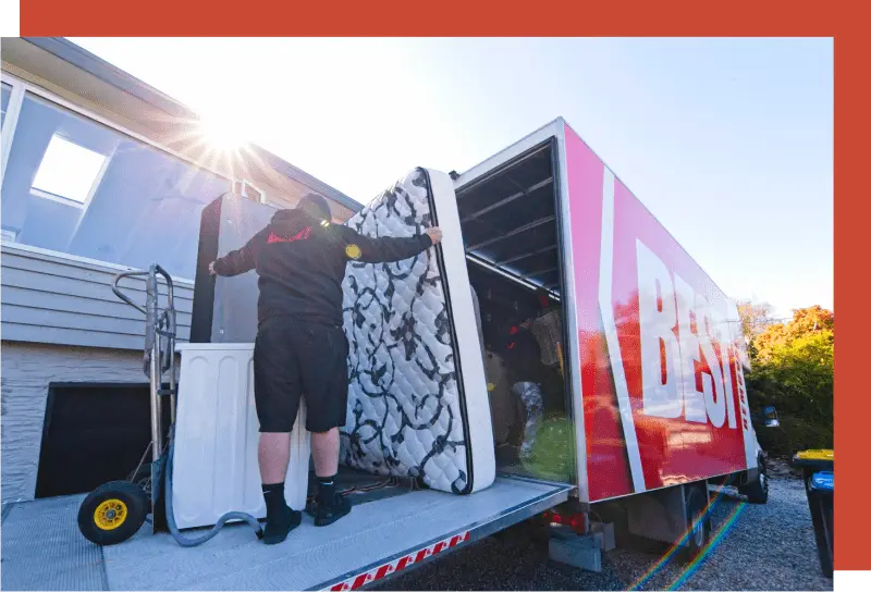 shifting a bed into a moving truck for transport